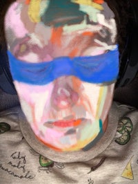 a person wearing headphones with a painting on their face