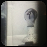 a light bulb is shown through a window