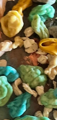 a close up of a pile of different colored poop