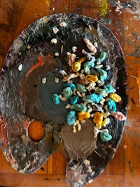 an artist's palette with a variety of paints on it