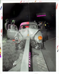 a photo of a car that has been wrecked at night